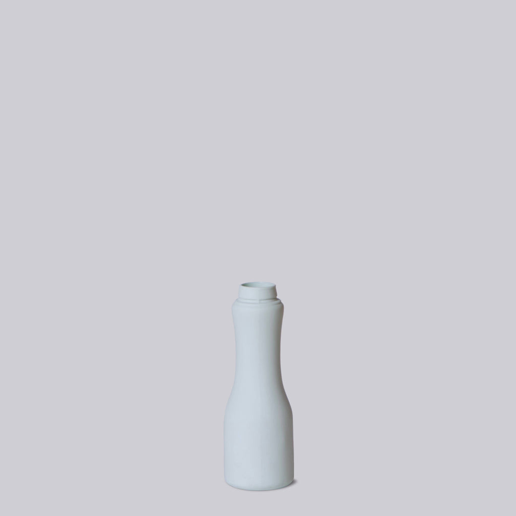 White ceramic bottle on a light gray background