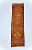 Long rectangular rug with geometric pattern on a white background