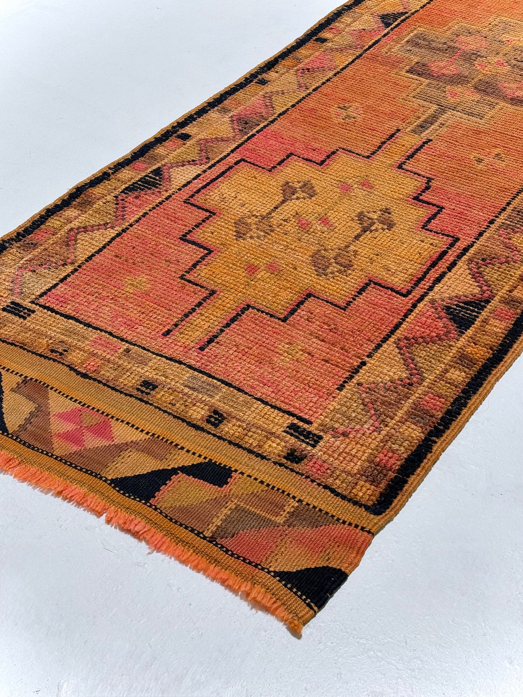 Small rug with geometric pattern on a white background