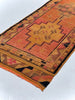Small rug with geometric pattern on a white background