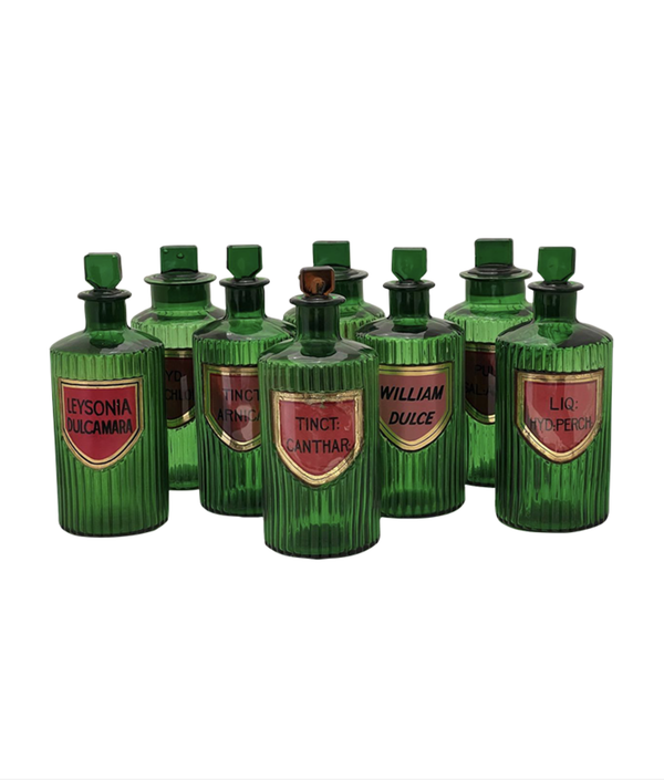 Set of green bottles with labels on a white background