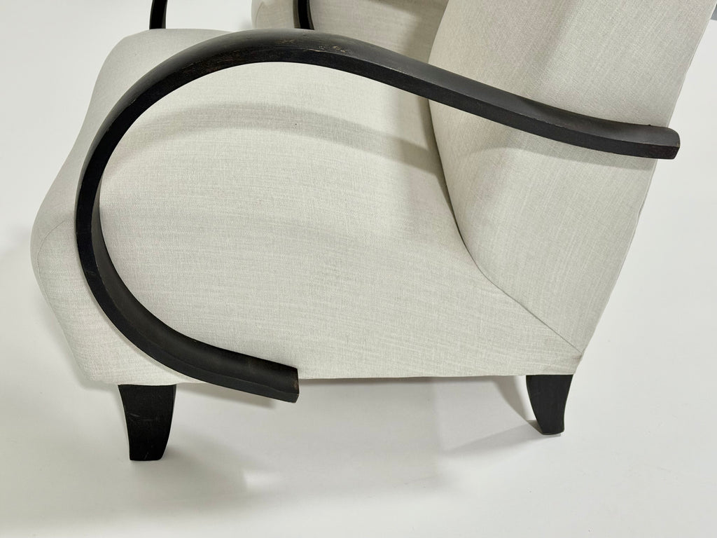 Close-up of a chair with black armrests and legs on a white background
