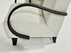 Close-up of a chair with black armrests and legs on a white background