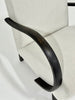 Close-up of a chair with a black wood armrest on a white background