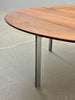 Wooden table with metal legs on a concrete floor
