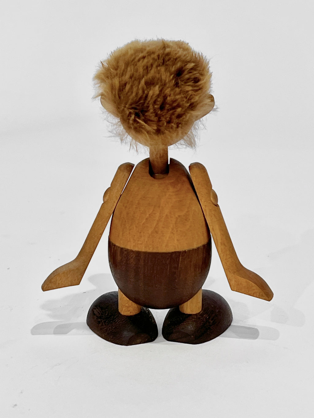 Wooden figurine with a textured head on a white background