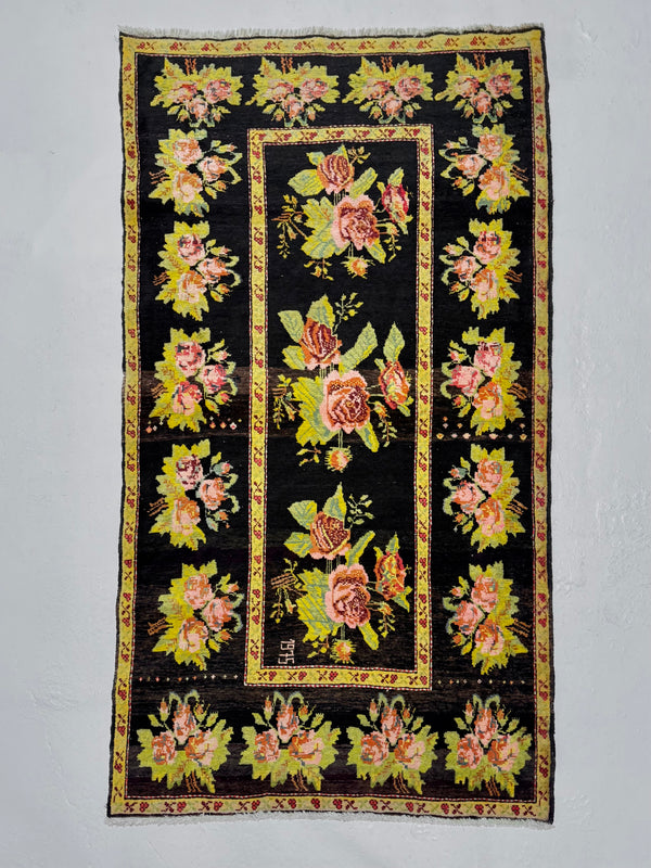 Decorative rug with floral patterns on a black background