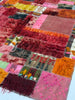 Patchwork rug with multicolored squares and textured patterns
