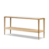 Console table with a white top and woven shelf on a white background