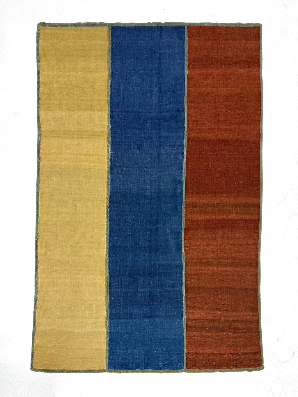Rectangular rug with yellow, blue, and orange stripes on a white background