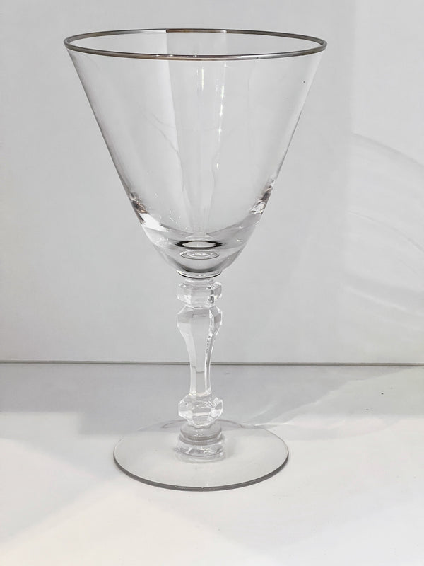 Clear glass cocktail glass with a thin stem on a white background