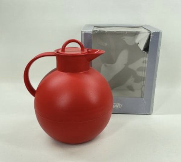 Red thermos with a silver box in the background on a white background