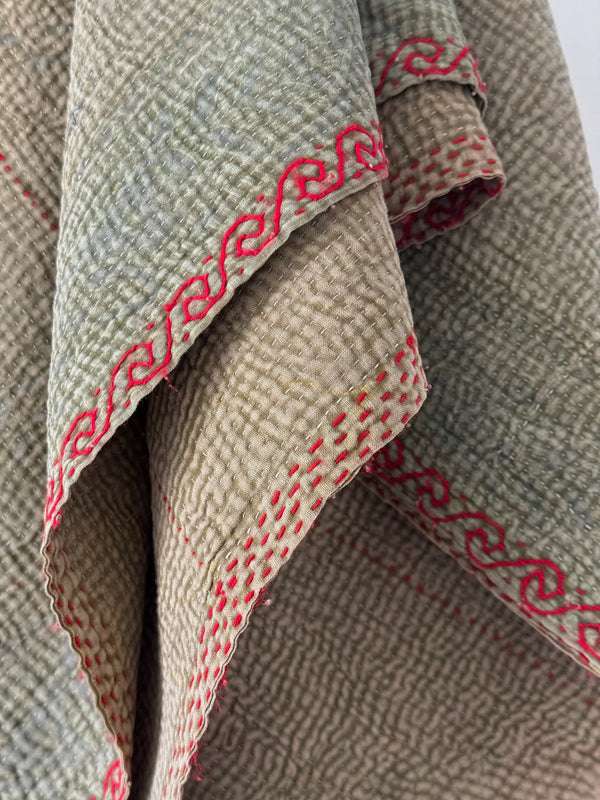 Textured fabric with red stitching detail