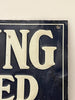 Close-up of a sign with partially visible text on a white background