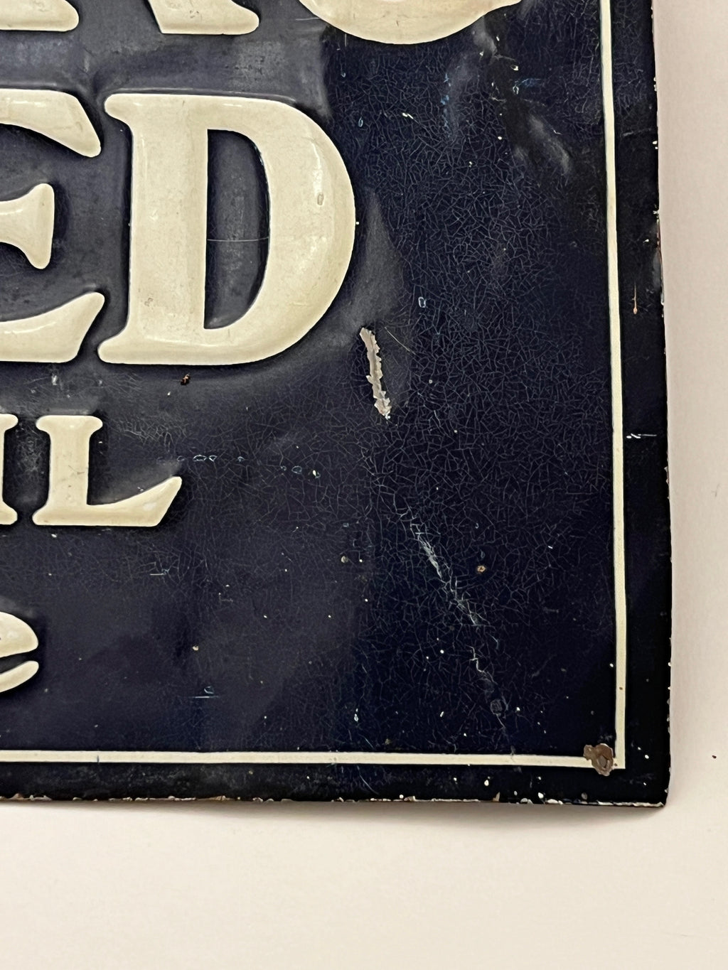 Corner of a vintage sign with worn and scratched surface