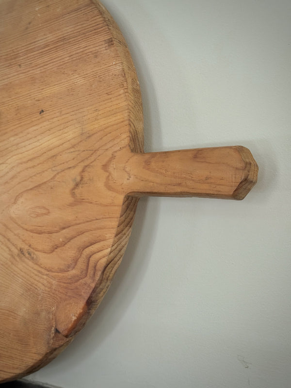 Wooden cutting board with a handle on a white background