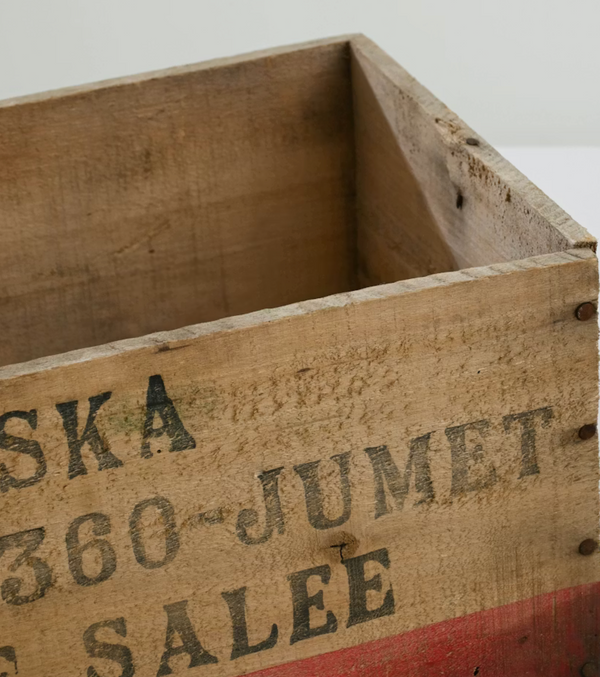 Vintage wooden crate with engraved text on a white background