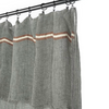 Gray curtains with brown and white stripes hanging on a rod against a white background