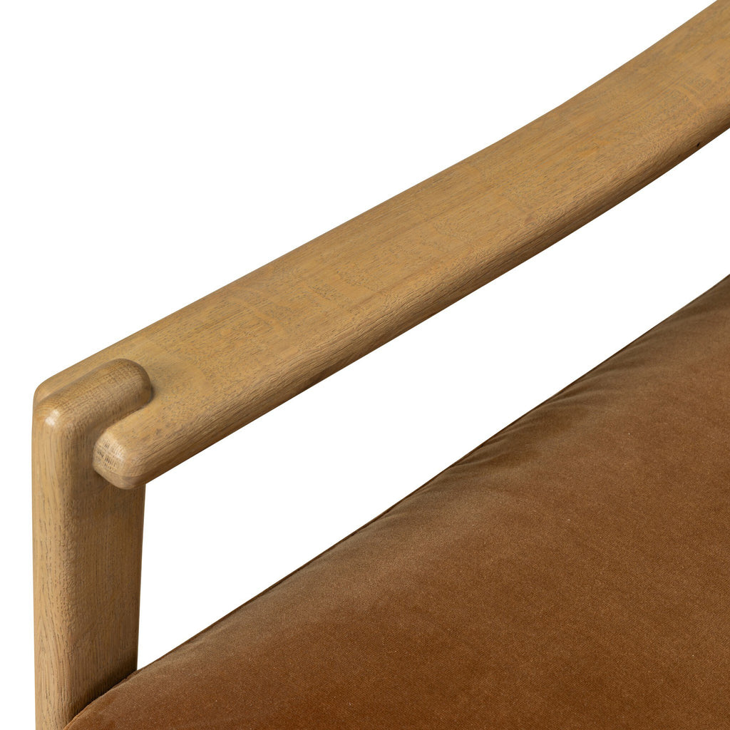 Close-up of a wooden chair armrest and brown cushion on a white background