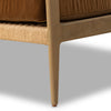 Close-up of a brown sofa with wooden legs on a gray background
