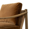 Brown velvet armchair with wooden armrests on a white background