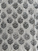 Textile pattern with black floral shapes on a light background