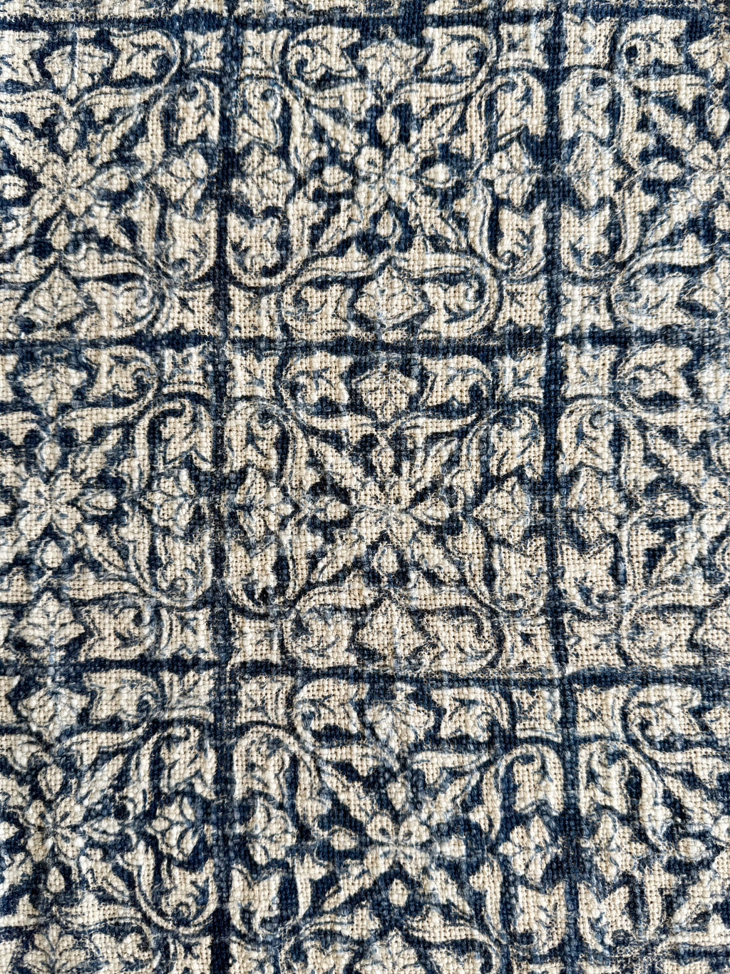 Close-up of a patterned fabric with blue and beige design