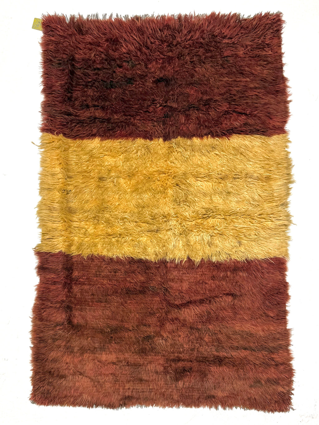 Rectangular shaggy rug with brown and beige stripes on a white background