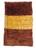 Rectangular shaggy rug with brown and beige stripes on a white background