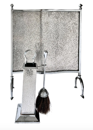 Silver fire screen with tools including a brush, poker, and shovel on a white background