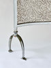 Metal fire screen with decorative pattern on a white background