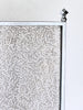 Metallic textured panel with a geometric design on a white background
