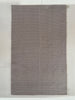 Gray textured cotton rug on a light wooden floor