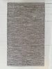 Gray textured area rug on a white wooden floor