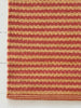 Striped red and beige rug on a white floor
