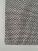 Textured gray and white patterned fabric on a plain background