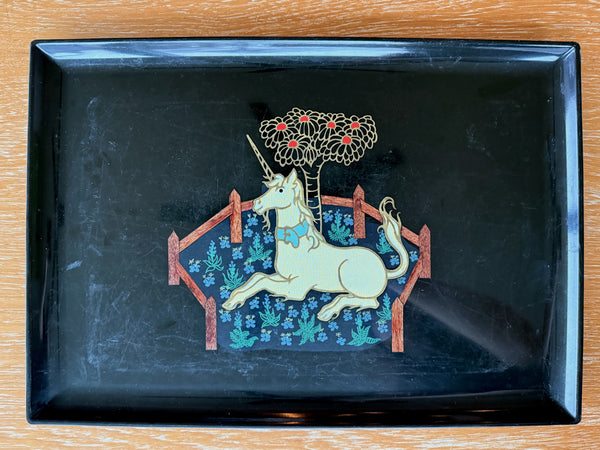 Decorative tray with a unicorn design on a black background