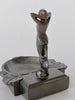 Decorative metal sculpture of a nude figure on a white background