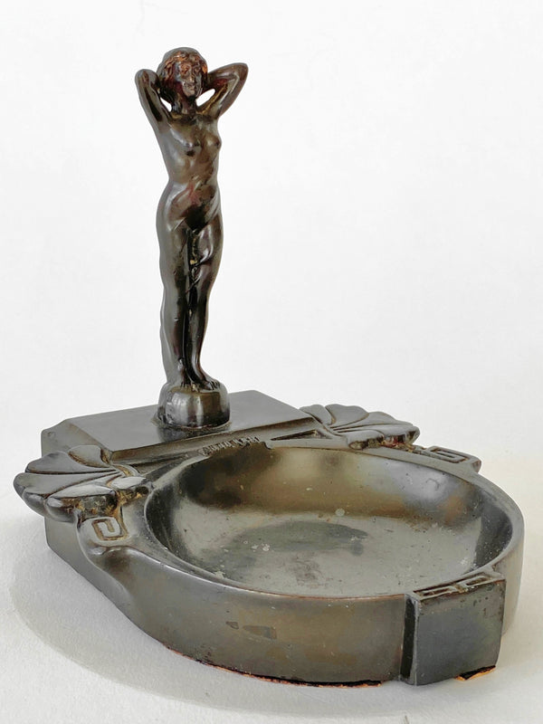 Decorative ashtray with a figurine on a white background