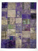 Patchwork rug with a mix of purple, blue, and gray colors on a white background