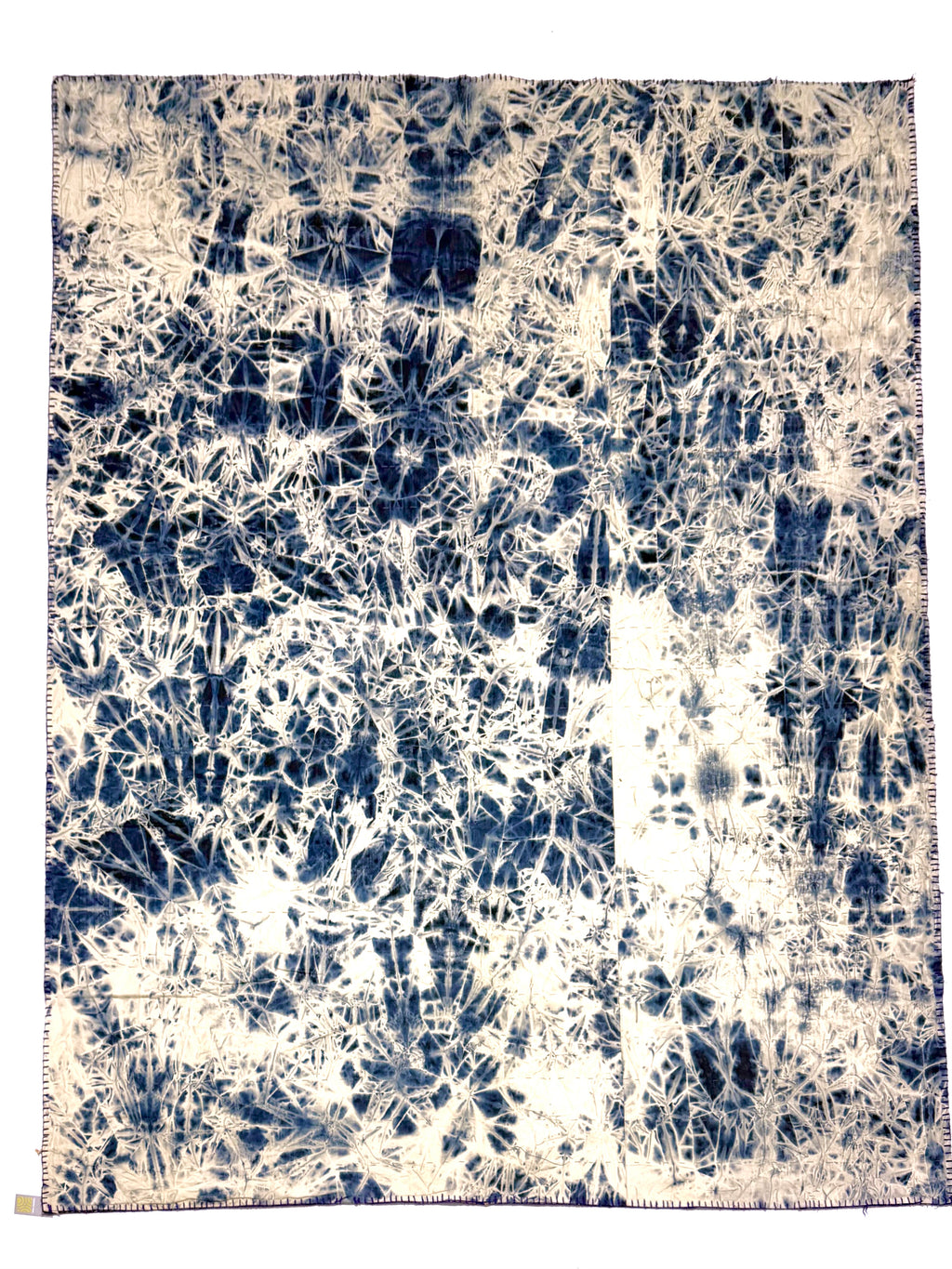 Tie-dye patterned fabric with blue and white colors