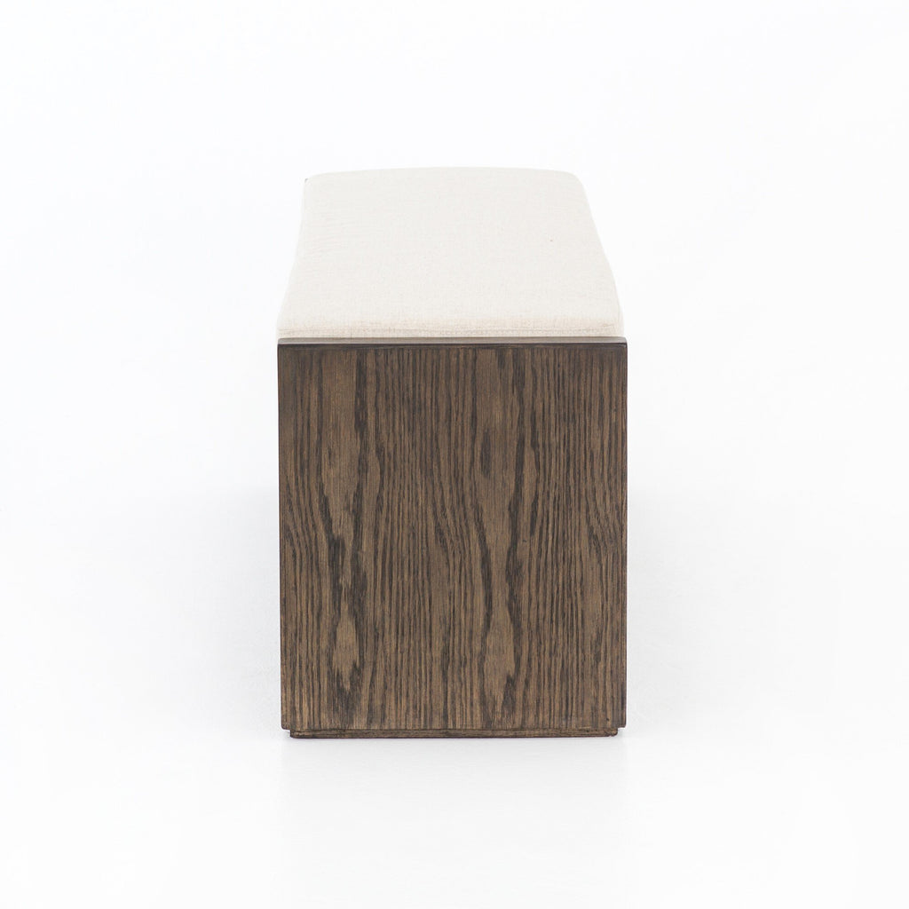 Wooden ottoman with a white cushion on a white background