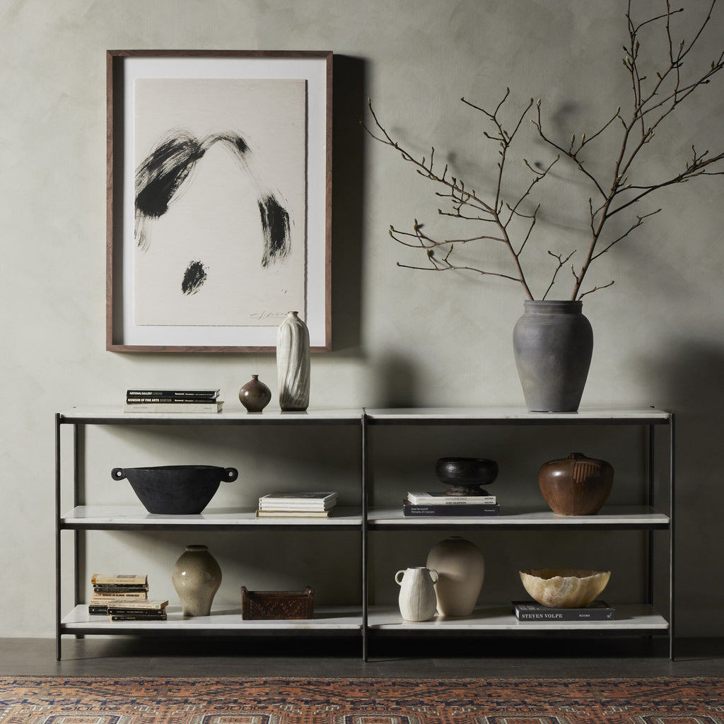 Shelving unit with decorative items against a gray wall