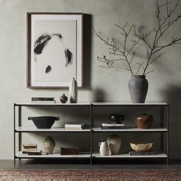 Shelving unit with decorative items against a gray wall