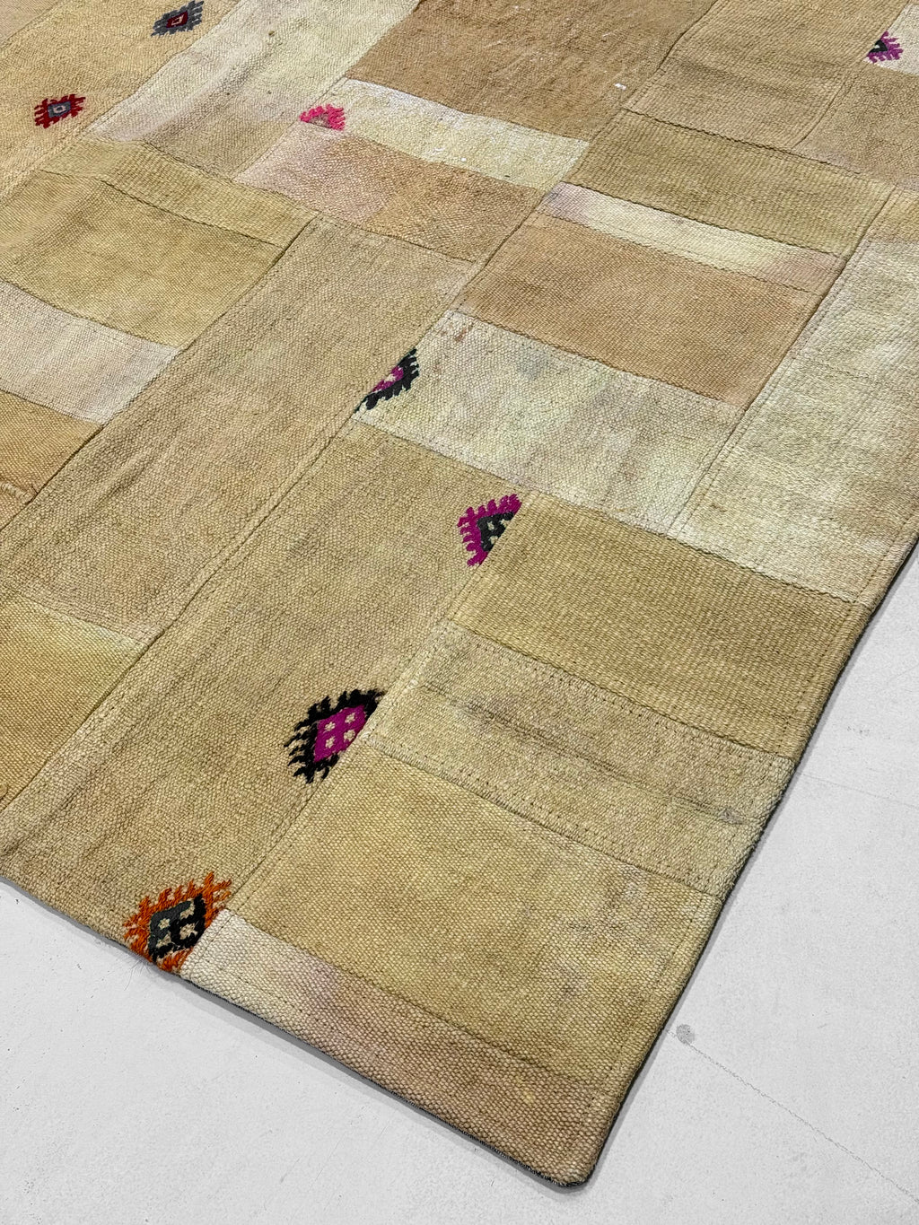 Patchwork rug with geometric pattern on a light background