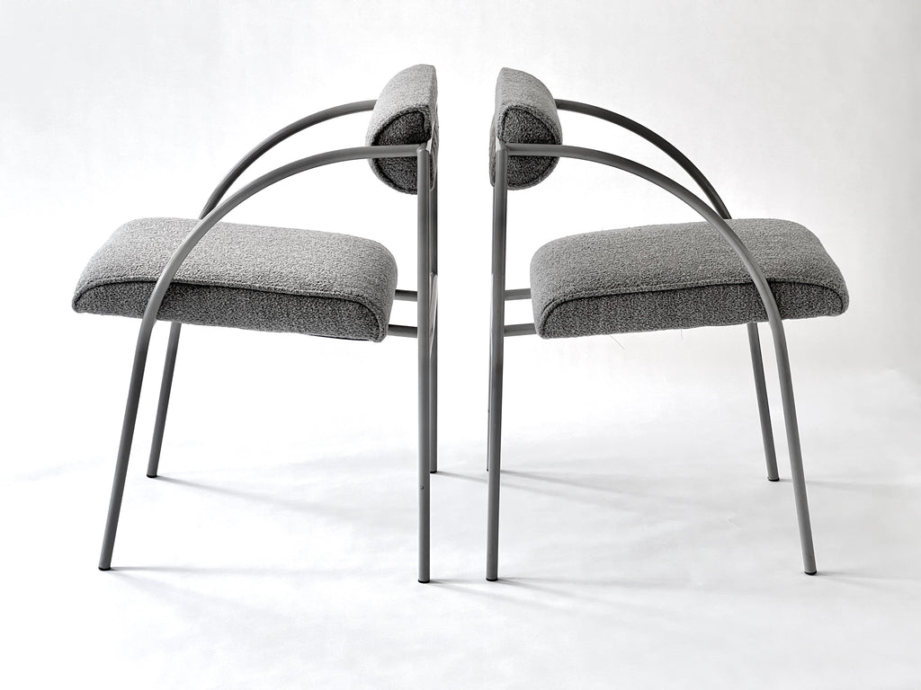 Two modern chairs with gray cushions on a white background