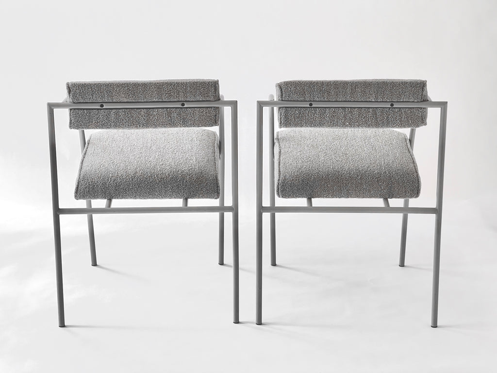 Two modern stools with gray seats and backs on a white background