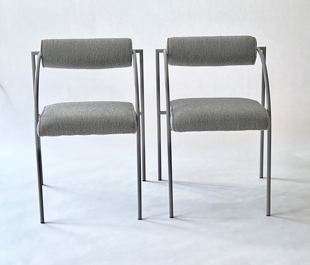 Two gray chairs with metal frames on a white background