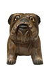 wood bulldog sculpture on a white surface with a beige background