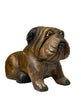 Bronze sculpture of a bulldog on a white surface with a neutral background